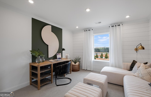 carpeted living room with ornamental molding