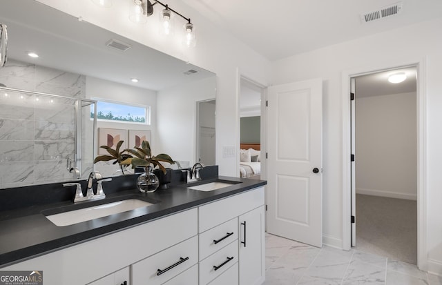 bathroom featuring an enclosed shower and vanity