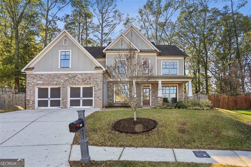 craftsman-style house featuring a garage, a porch, and a front yard