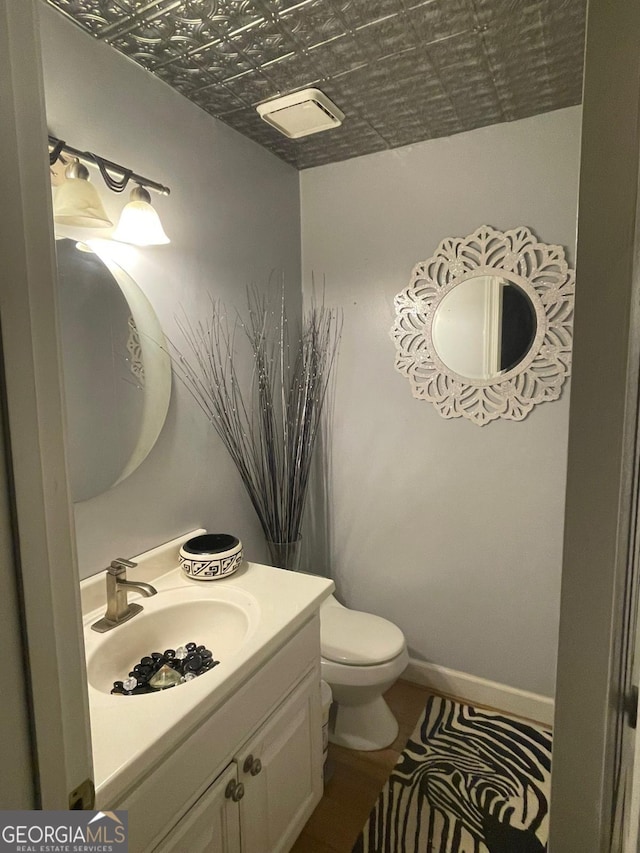 bathroom featuring toilet and vanity