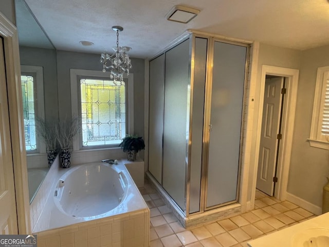 bathroom with tile patterned flooring, a notable chandelier, and separate shower and tub