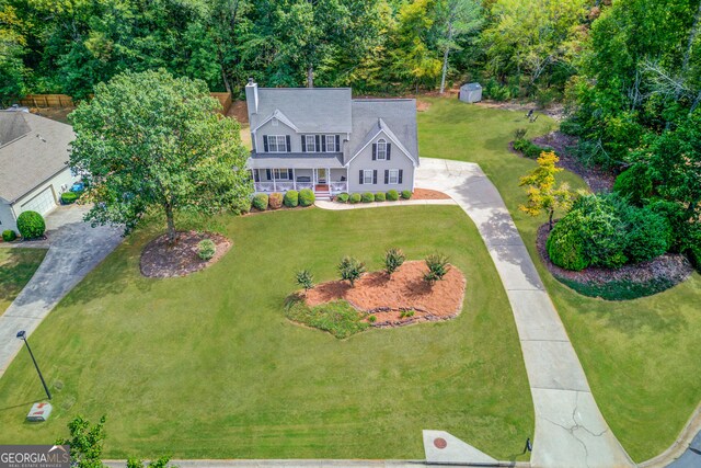 view of front of house with covered porch and a front lawn