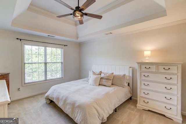 bedroom featuring a raised ceiling, visible vents, and light colored carpet