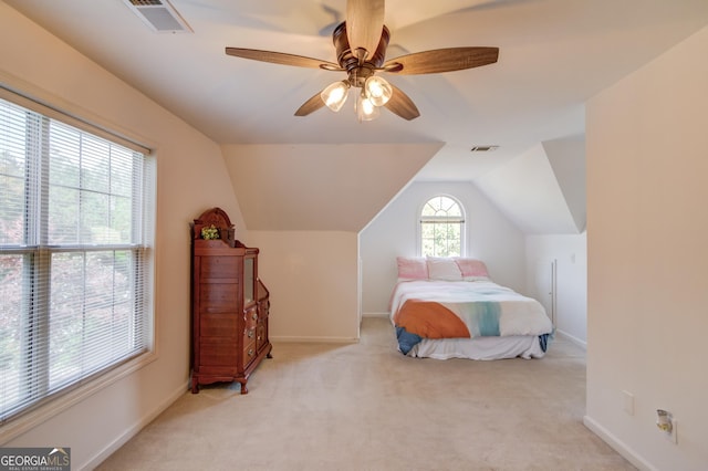 bedroom featuring light colored carpet, visible vents, vaulted ceiling, and baseboards