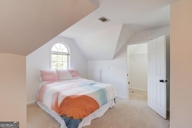 bedroom featuring lofted ceiling, light carpet, visible vents, and baseboards