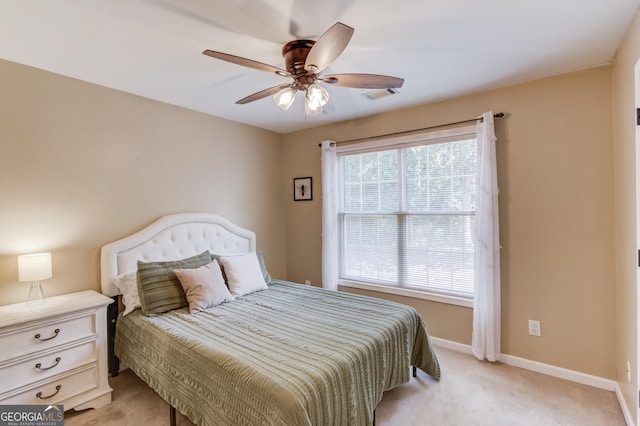 bedroom with light colored carpet, visible vents, ceiling fan, and baseboards