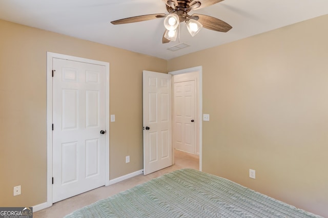 unfurnished bedroom featuring a ceiling fan, light colored carpet, visible vents, and baseboards