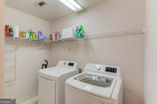 washroom featuring washer and dryer, laundry area, and visible vents