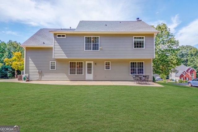 rear view of property featuring a patio area and a yard