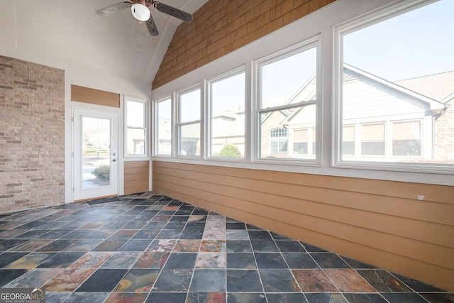 unfurnished sunroom with vaulted ceiling and ceiling fan