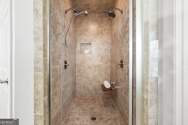 bathroom with tiled shower