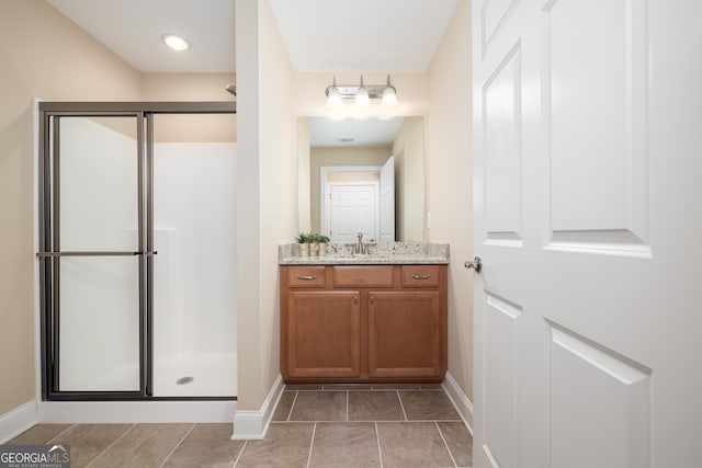 bathroom with vanity and a shower with door