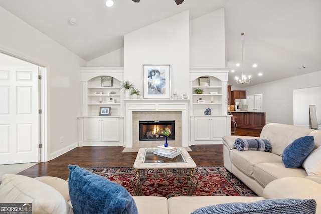 living room featuring dark hardwood / wood-style flooring, ceiling fan with notable chandelier, built in features, and high vaulted ceiling