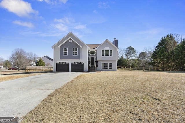 view of front of home with a front lawn and a garage