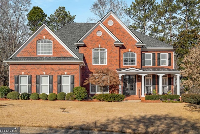 view of front facade featuring a front yard and covered porch