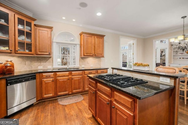 kitchen with sink, decorative light fixtures, stainless steel dishwasher, a chandelier, and black gas stovetop