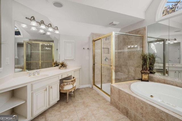 bathroom with tile patterned floors, vaulted ceiling, separate shower and tub, and vanity