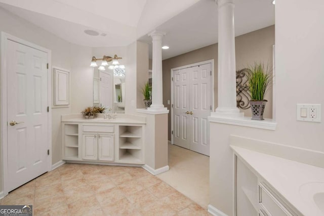 bathroom featuring decorative columns, tile patterned flooring, and vanity