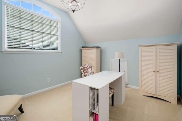 carpeted home office with a notable chandelier and vaulted ceiling