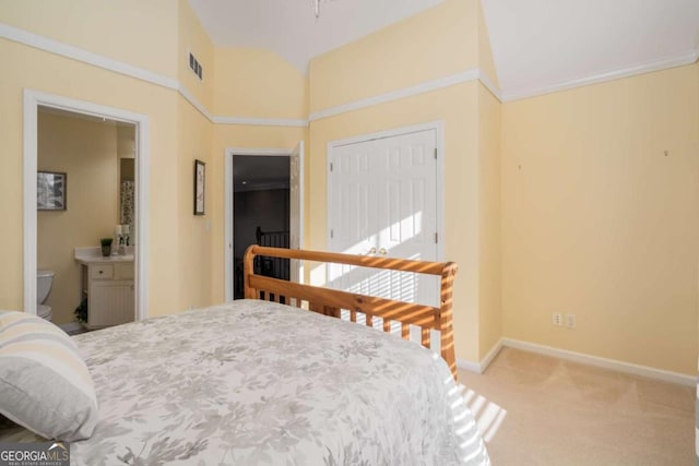 carpeted bedroom featuring ensuite bath and a closet