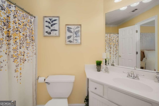 bathroom with toilet, crown molding, walk in shower, and vanity