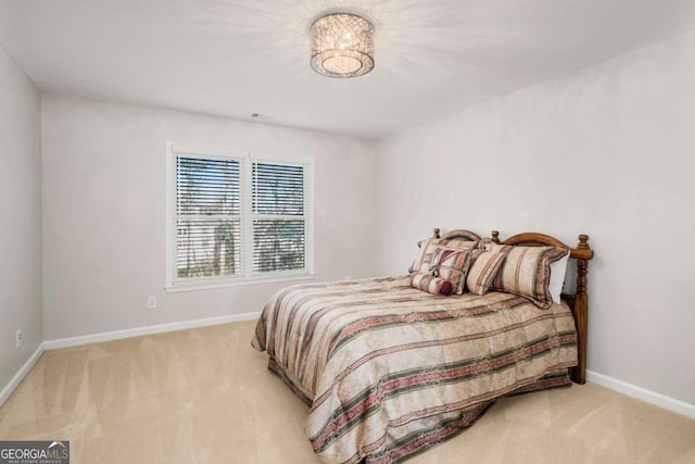 carpeted bedroom with a notable chandelier