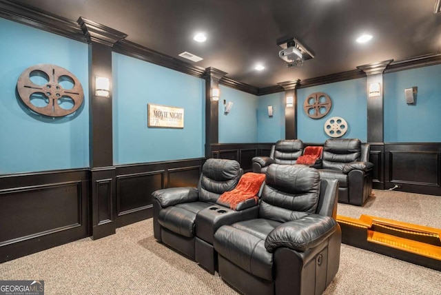 carpeted cinema room with crown molding and decorative columns