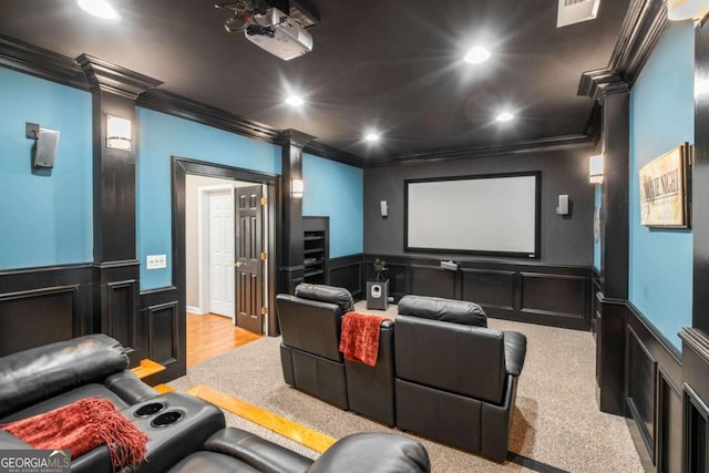 carpeted cinema room with ornamental molding