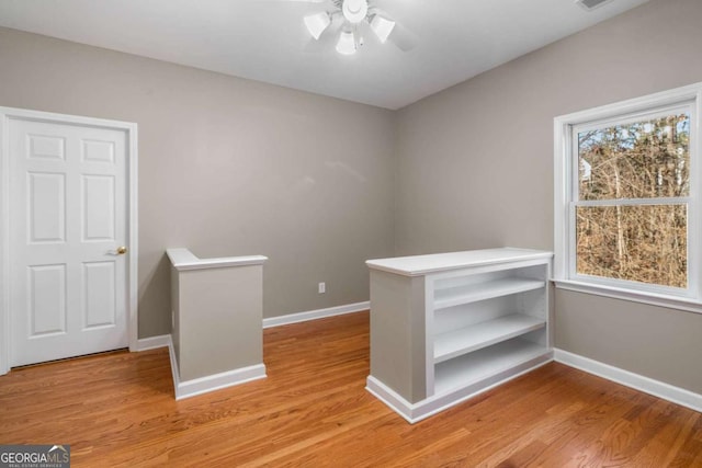 interior space featuring ceiling fan, light wood-type flooring, and a wealth of natural light