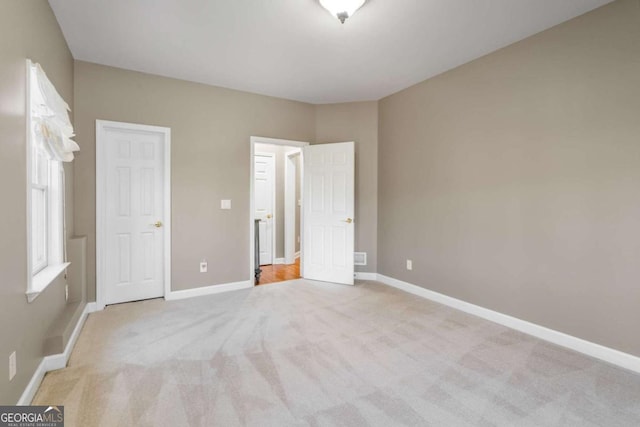 unfurnished bedroom with light carpet