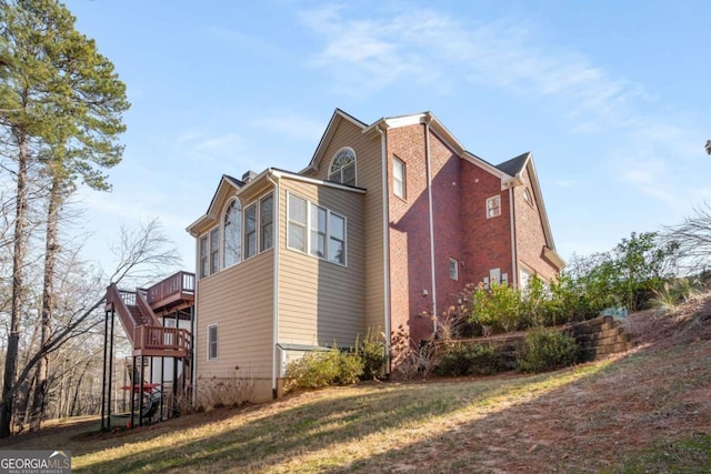 view of side of home featuring a wooden deck