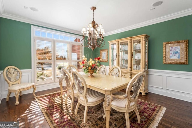 dining space with ornamental molding, a chandelier, and dark hardwood / wood-style floors