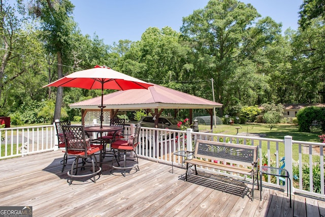 wooden deck with a gazebo and a lawn