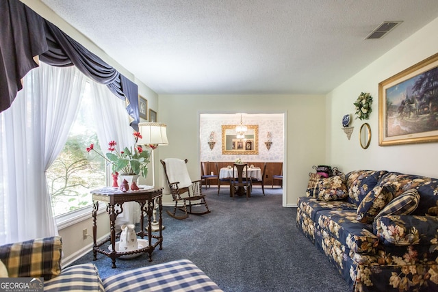 carpeted living room with a textured ceiling