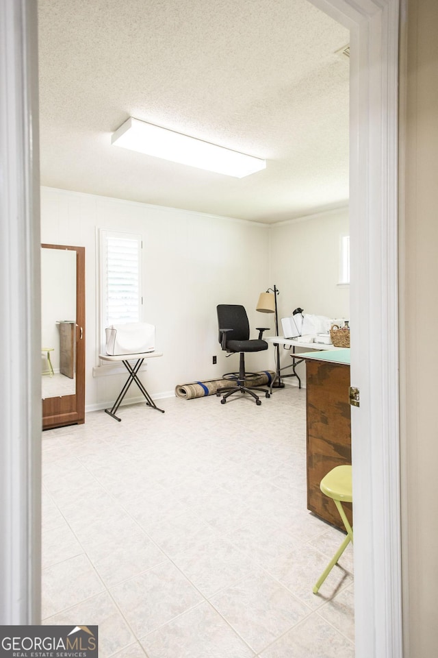 office area with a textured ceiling and tile patterned floors