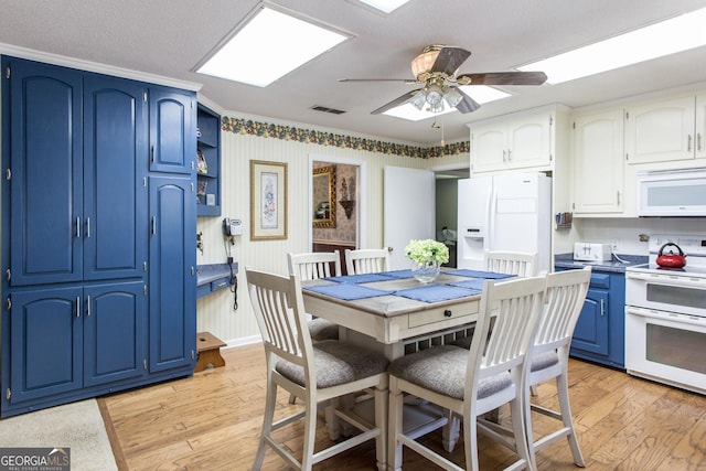 dining room featuring ceiling fan, light wood-type flooring, and crown molding