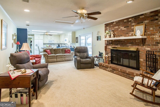 carpeted living room with a fireplace, a textured ceiling, ceiling fan, and crown molding