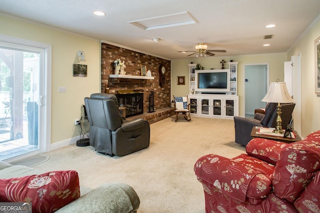 carpeted living room featuring ceiling fan, a brick fireplace, crown molding, and a textured ceiling