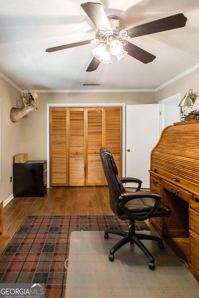 office space with ceiling fan, dark hardwood / wood-style flooring, crown molding, and a textured ceiling