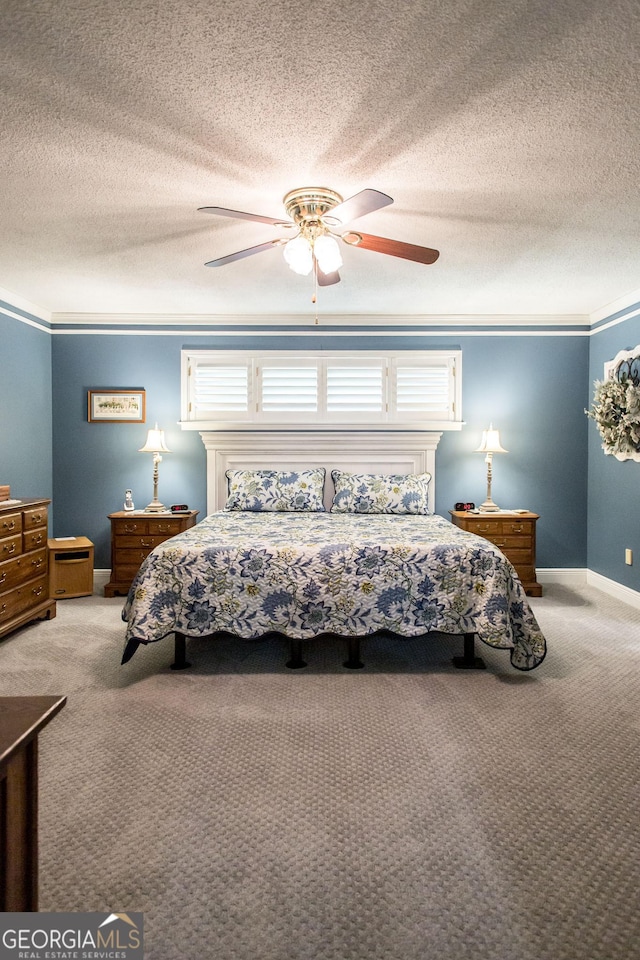 carpeted bedroom with ceiling fan and ornamental molding