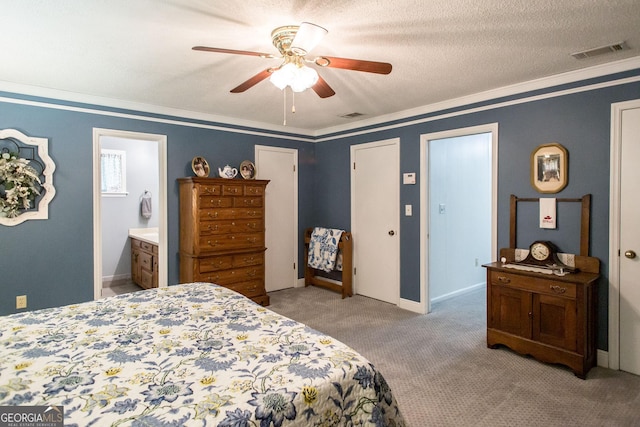 carpeted bedroom with ensuite bathroom, a textured ceiling, ceiling fan, and crown molding