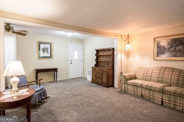 living room with ceiling fan and carpet flooring