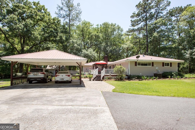 view of front of property with a wooden deck and a front lawn