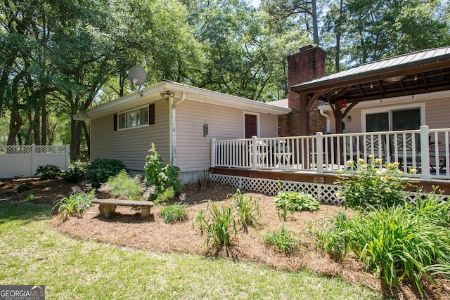 rear view of house featuring a gazebo and a deck