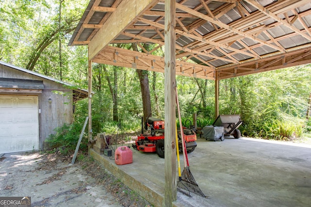 view of patio with a garage and an outbuilding