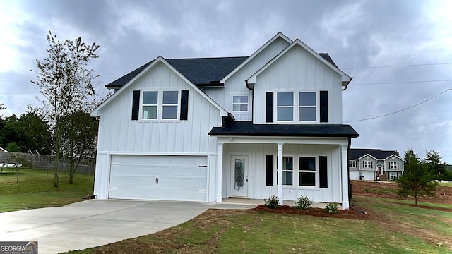 view of front of property featuring a garage and a front lawn