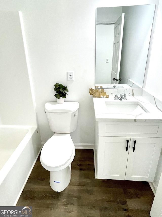 bathroom featuring toilet, wood-type flooring, and vanity