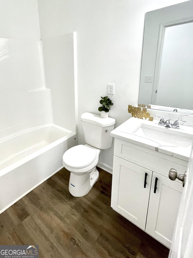 full bathroom with toilet, bathing tub / shower combination, wood-type flooring, and vanity