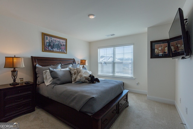 bedroom featuring light carpet