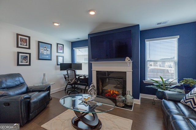 living room with a healthy amount of sunlight and dark hardwood / wood-style floors